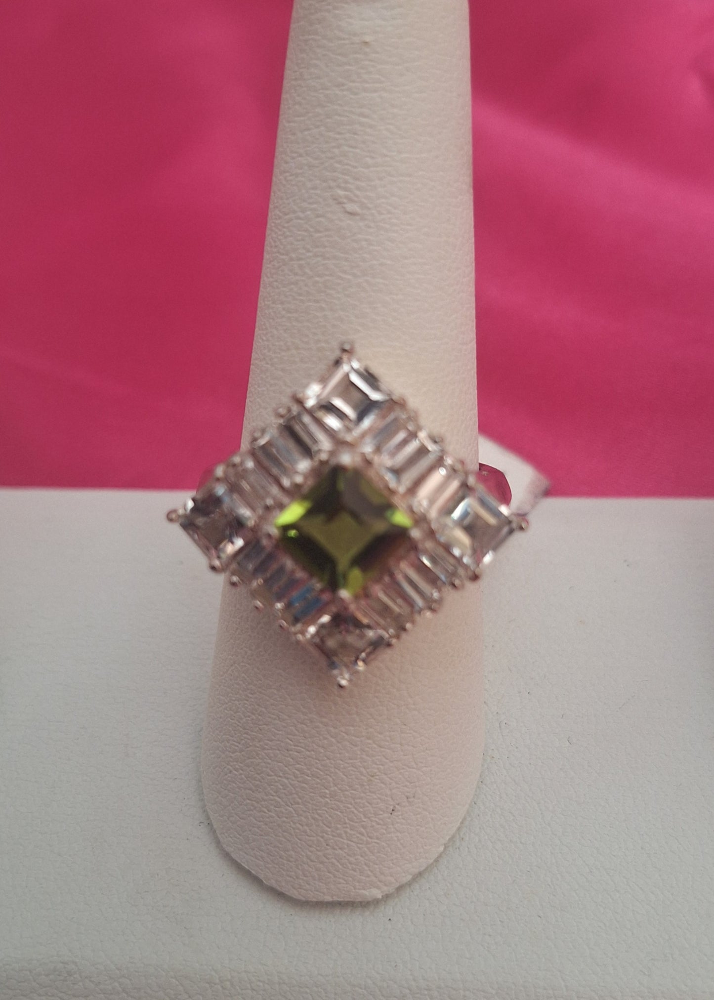 a sterling silver peridot center and white topaz accents