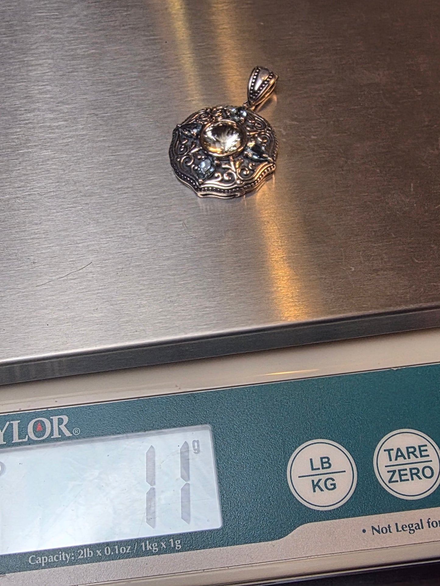 925 Sterling Silver Pendant featuring a central labradorite gemstone surrounded by blue topaz accents and intricate scrollwork