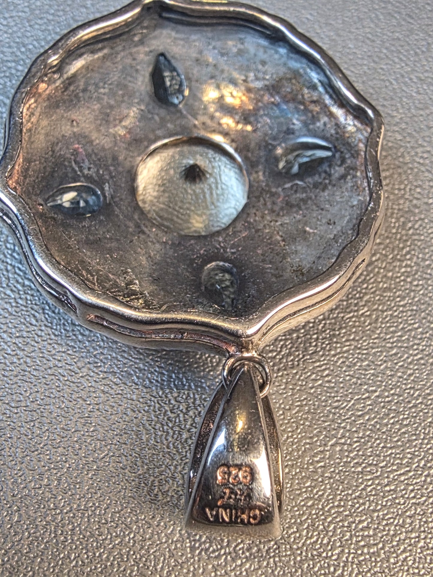 925 Sterling Silver Pendant featuring a central labradorite gemstone surrounded by blue topaz accents and intricate scrollwork