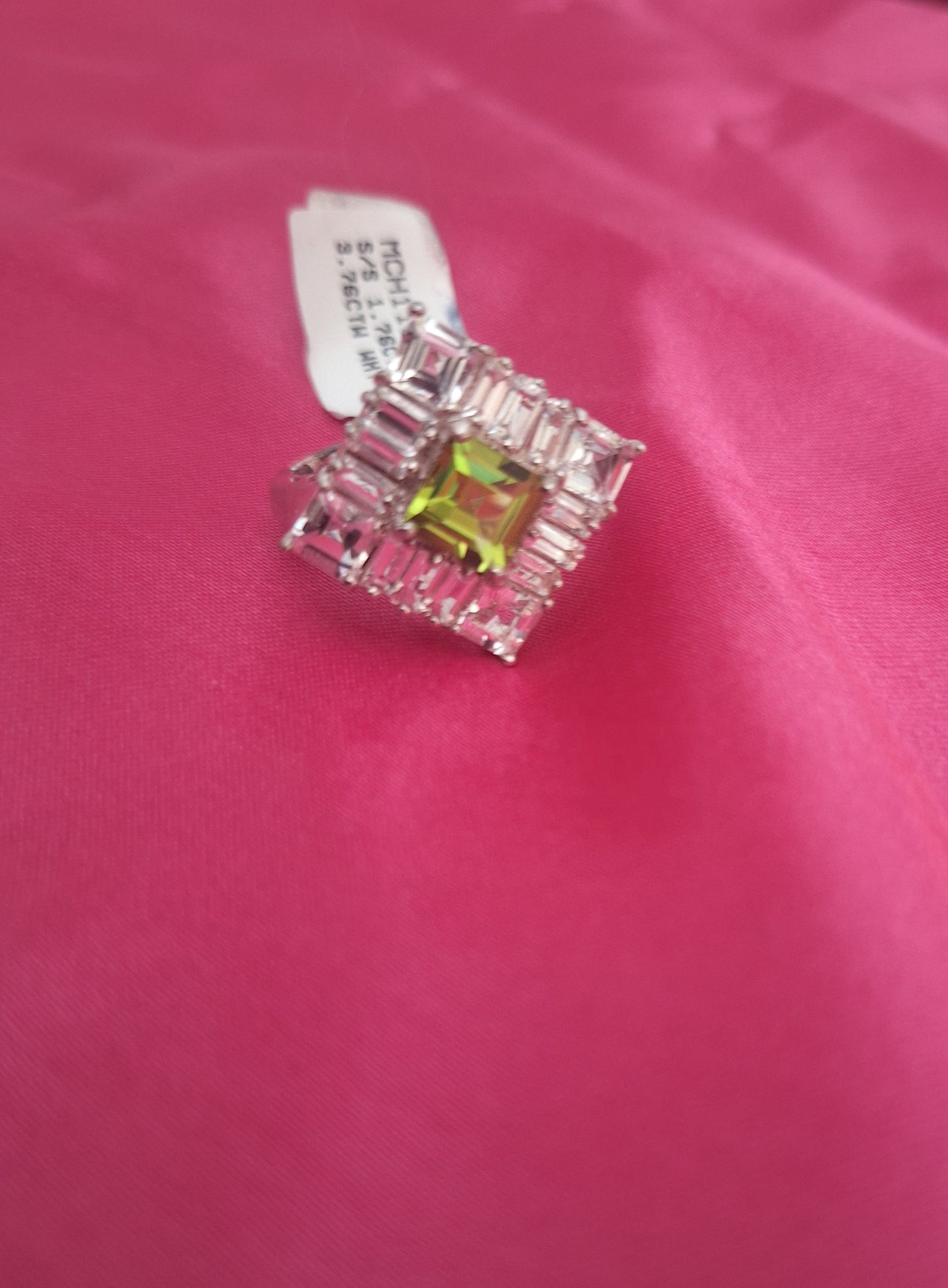 a sterling silver peridot center and white topaz accents